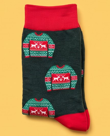 Dark green moJJa crew socks with a knitted ugly-sweater pattern and red cuffs