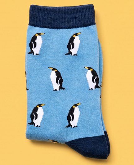 Light blue moJJa crew socks with penguins and navy cuffs